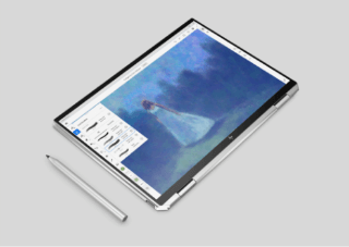 Spectre x360 in tablet mode and with an HP pen laid next to it